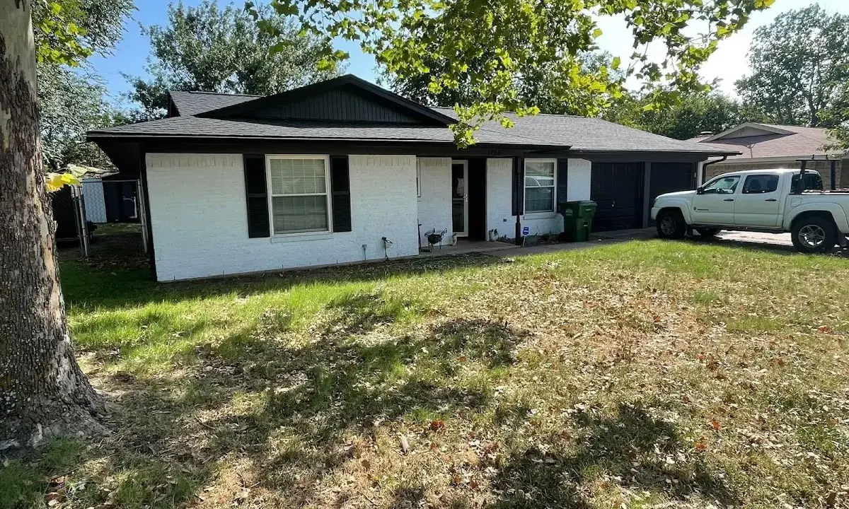 Professional roofing crew working on a residential roof in Vernon